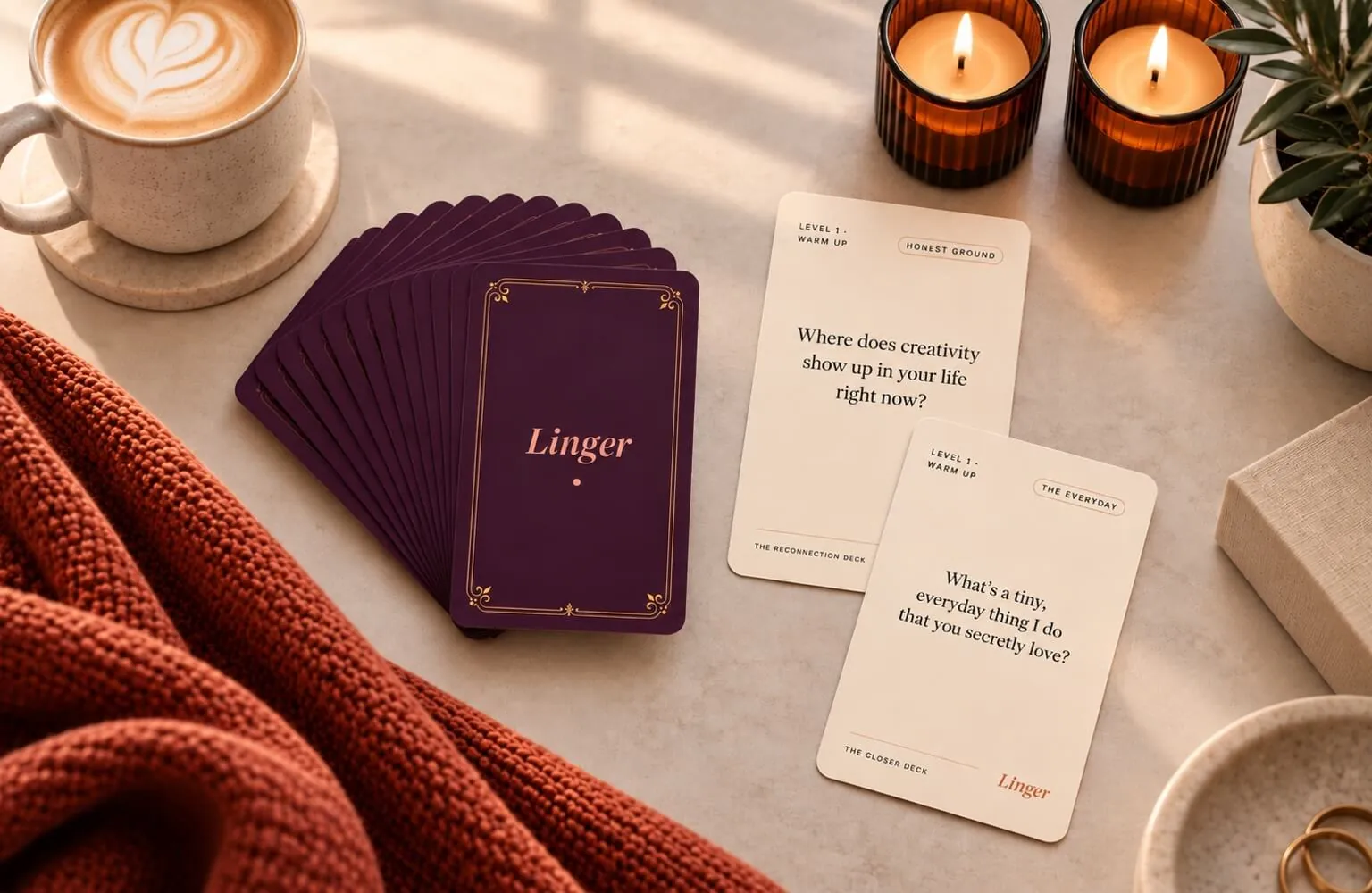 Plum Linger conversation cards arranged beside two question cards, coffee, and lit candles